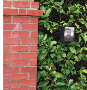 Door King keypad on post in bushes