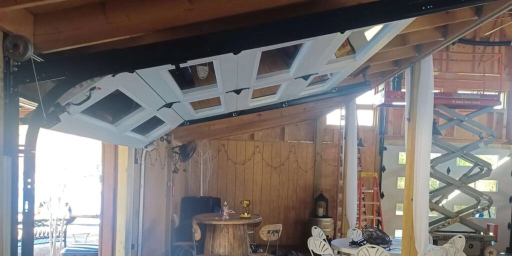 Garage door torsion springs installed above a residential garage door during maintenance inspection | How Long Do Garage Door Springs Last